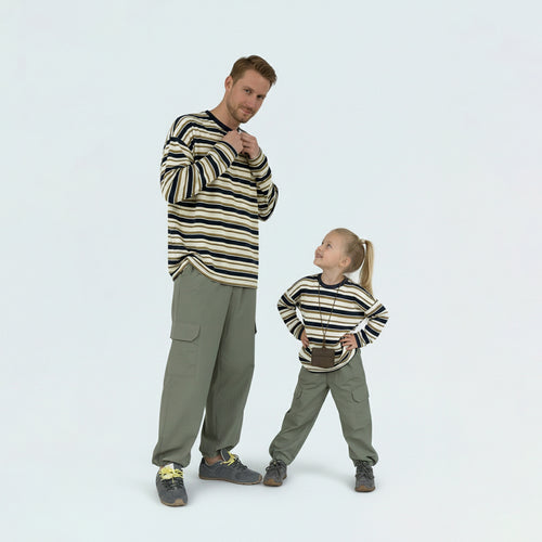 Father and son bonding in matching family outfits, wearing comfortable contrast striped long sleeve shirts.