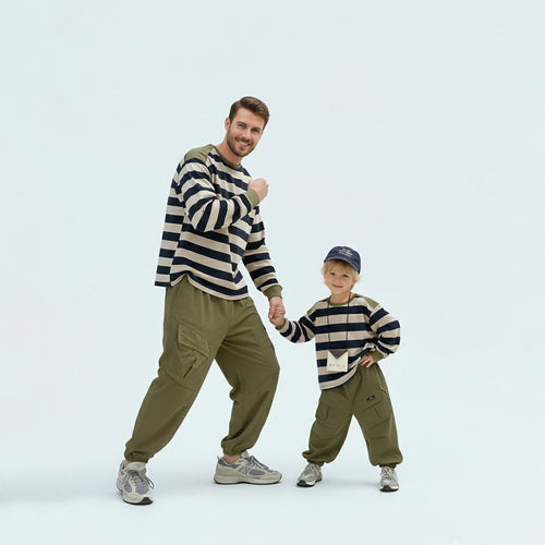 Father and son bonding in matching family outfits wearing comfortable green striped cotton shirts.