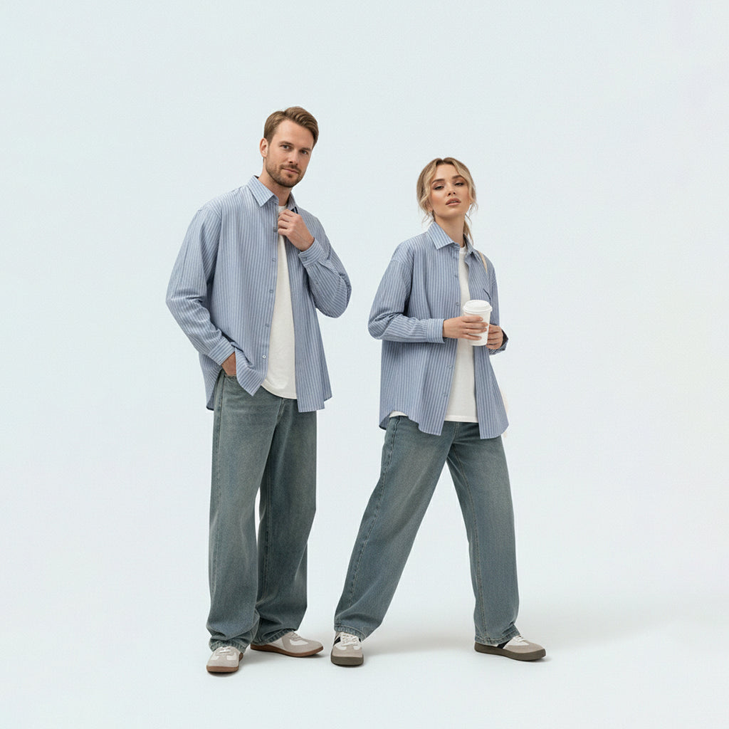 Couple in coordinated matching family outfits featuring the unisex sky blue striped shirt for a relaxed holiday vibe.