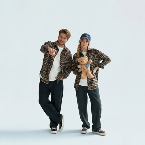 Couple in coordinated matching family outfits featuring the unisex brown plaid shirt for a relaxed holiday vibe.