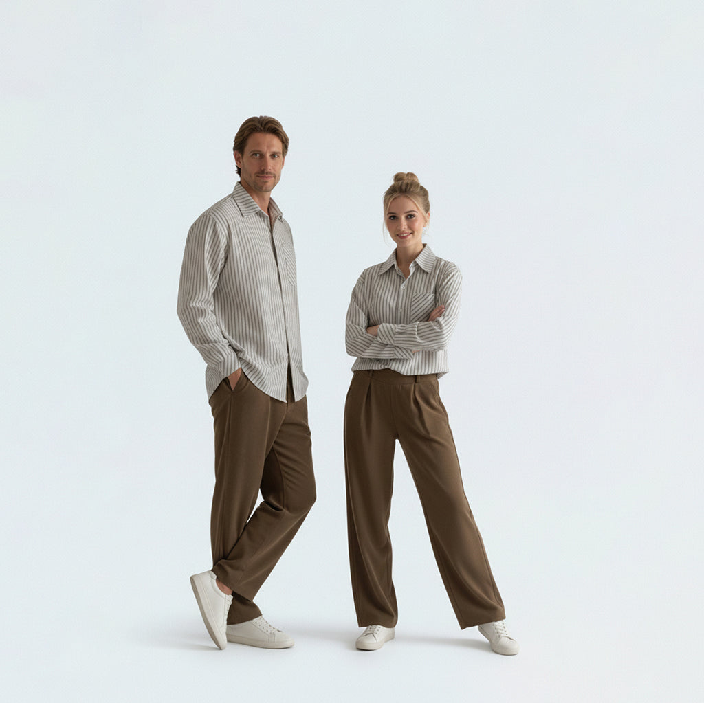 Couple in coordinated matching family outfits featuring the unisex blue striped shirt for a relaxed holiday vibe.