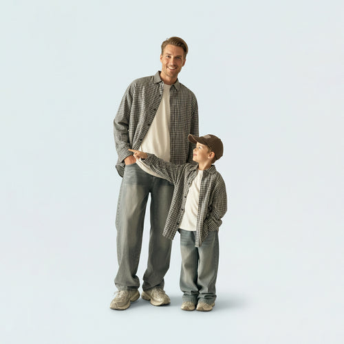 Father and son bonding in matching family outfits, wearing comfortable and breathable grey gingham cotton shirts.