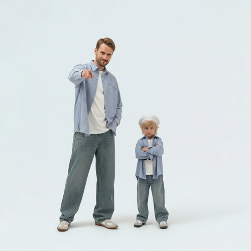 Father and child bonding in matching family outfits wearing comfortable 100% cotton sky blue striped shirts.