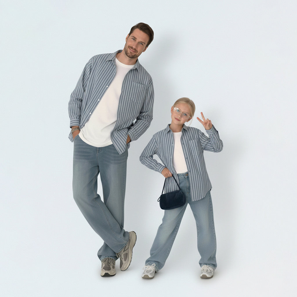 Dad and son bonding in matching family outfits, wearing smart striped shirts for a cool Aussie outdoor lifestyle.