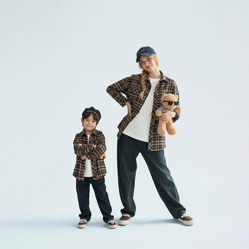 Mother and son in matching family outfits showcasing the stylish brown plaid shirt mini-me travel style.