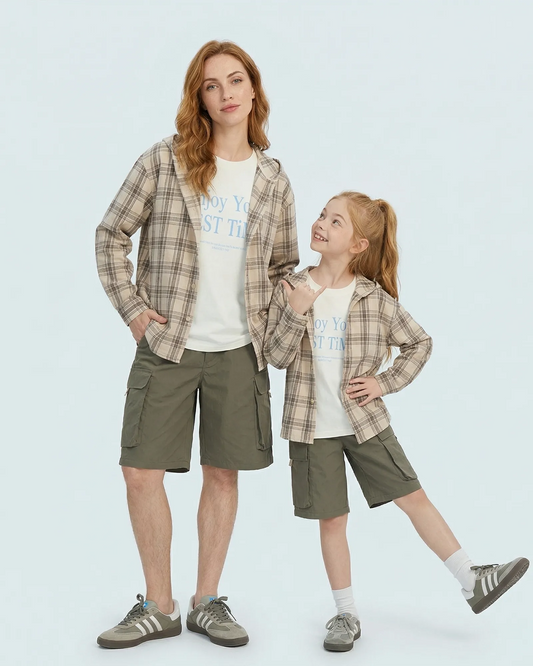 Mother and son in matching family outfits wearing lazy style hooded checkered cotton jackets.
