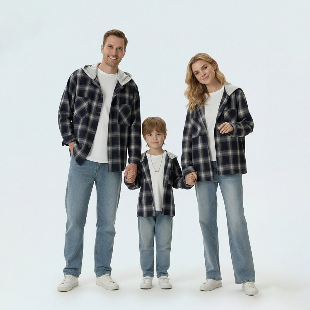 Full family in matching family outfits wearing black and white plaid hooded shirt jackets for a coordinated look.