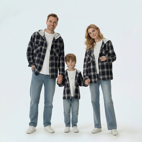 Full family in matching family outfits wearing black and white plaid hooded shirt jackets for a coordinated look.
