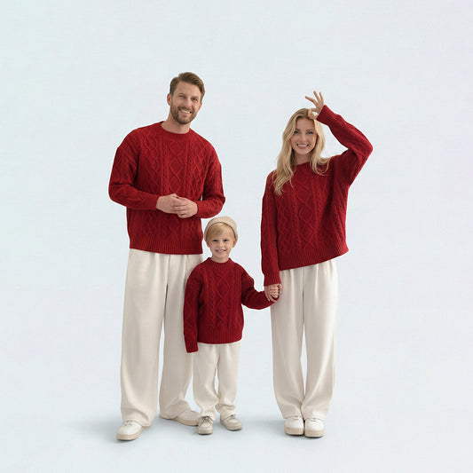 Full family in matching family outfits featuring red cable knit sweaters for Christmas and New Year photos.