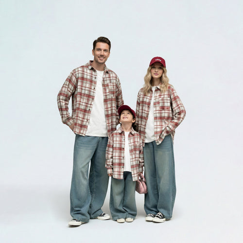 Full family in matching family outfits wearing red plaid brushed cotton shirts for a coordinated autumn look.