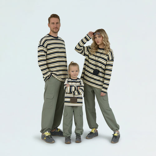 Full family in matching family outfits wearing contrast striped long sleeve tees for a coordinated spring look.