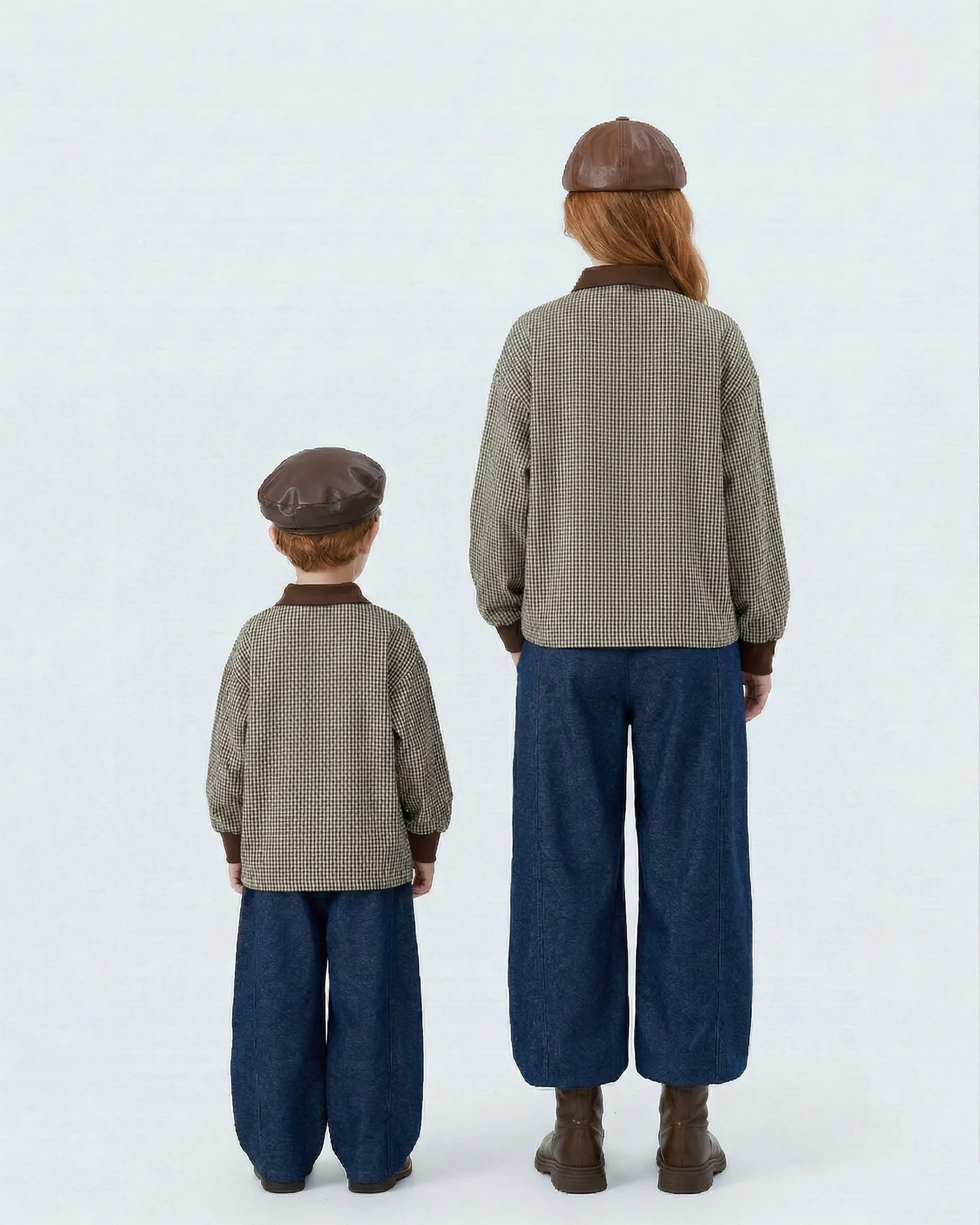 Back view of mommy and me matching plaid polo shirts showing oversized streetwear fit.