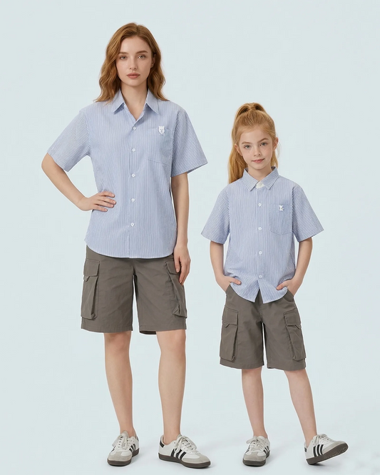 Mother and daughter in matching family outfits: timeless blue and white striped shirts with a preppy white collar.