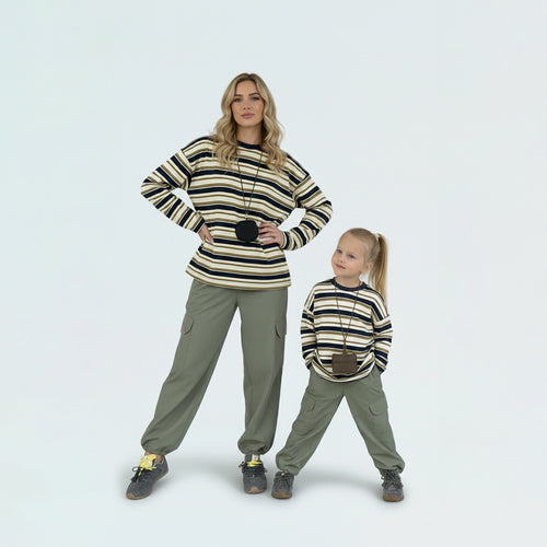 Mother and daughter in mommy and me outfits, showcasing the mini-me style in soft striped cotton.