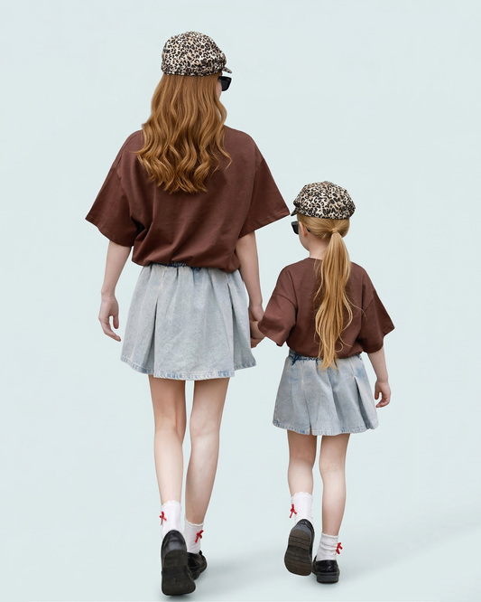 Close-up of mother and son in matching animal illustration shirts solving the style gap.